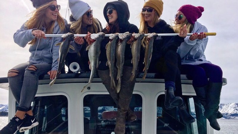 a group of people riding on the back of a truck