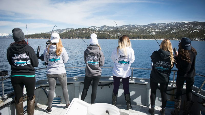 a group of people sitting at a dock