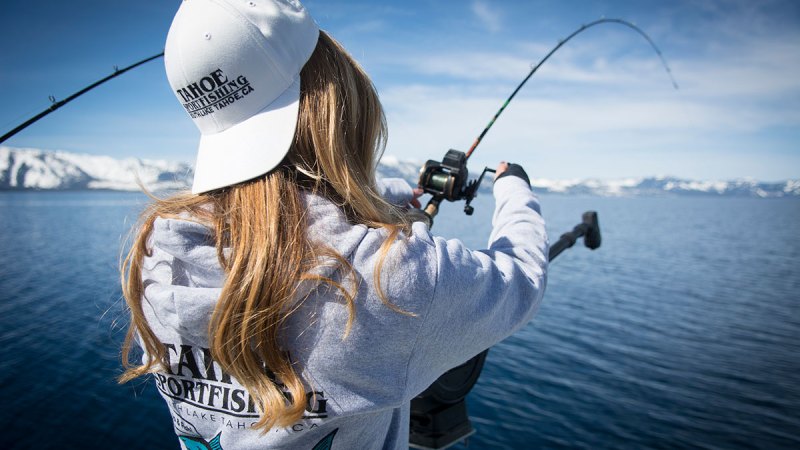 a person standing next to a body of water