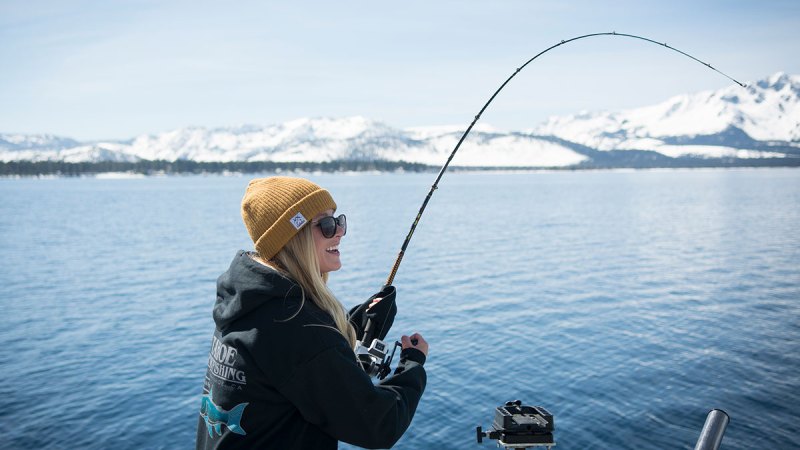 a man standing next to a body of water