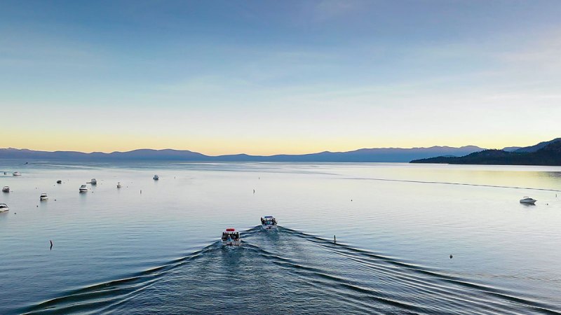 a group of people standing next to a body of water