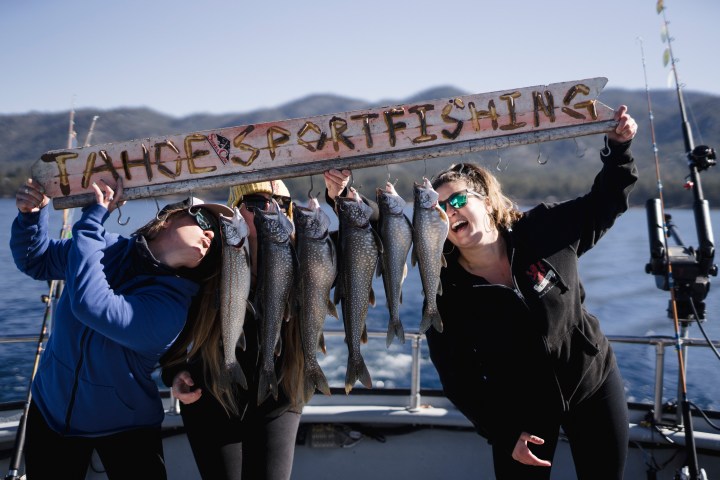 a group of people standing in front of a fish