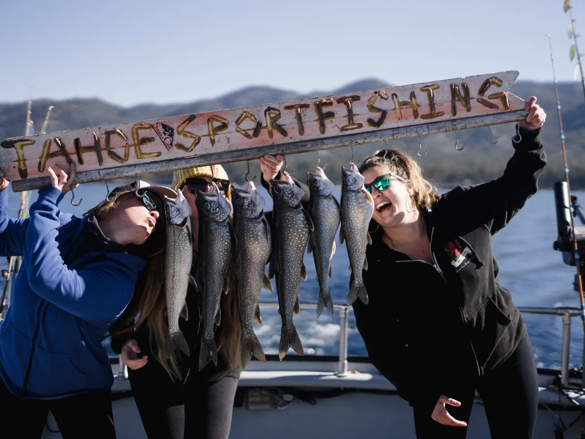 a group of people standing in front of a fish