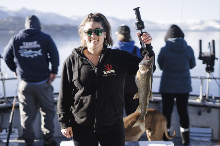 a person standing next to a dog