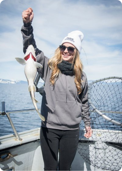 Careers a woman holding a fish on a boat