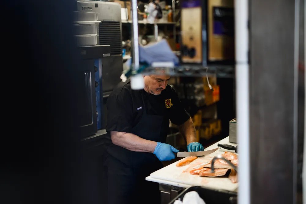 a man preparing food in a kitchen