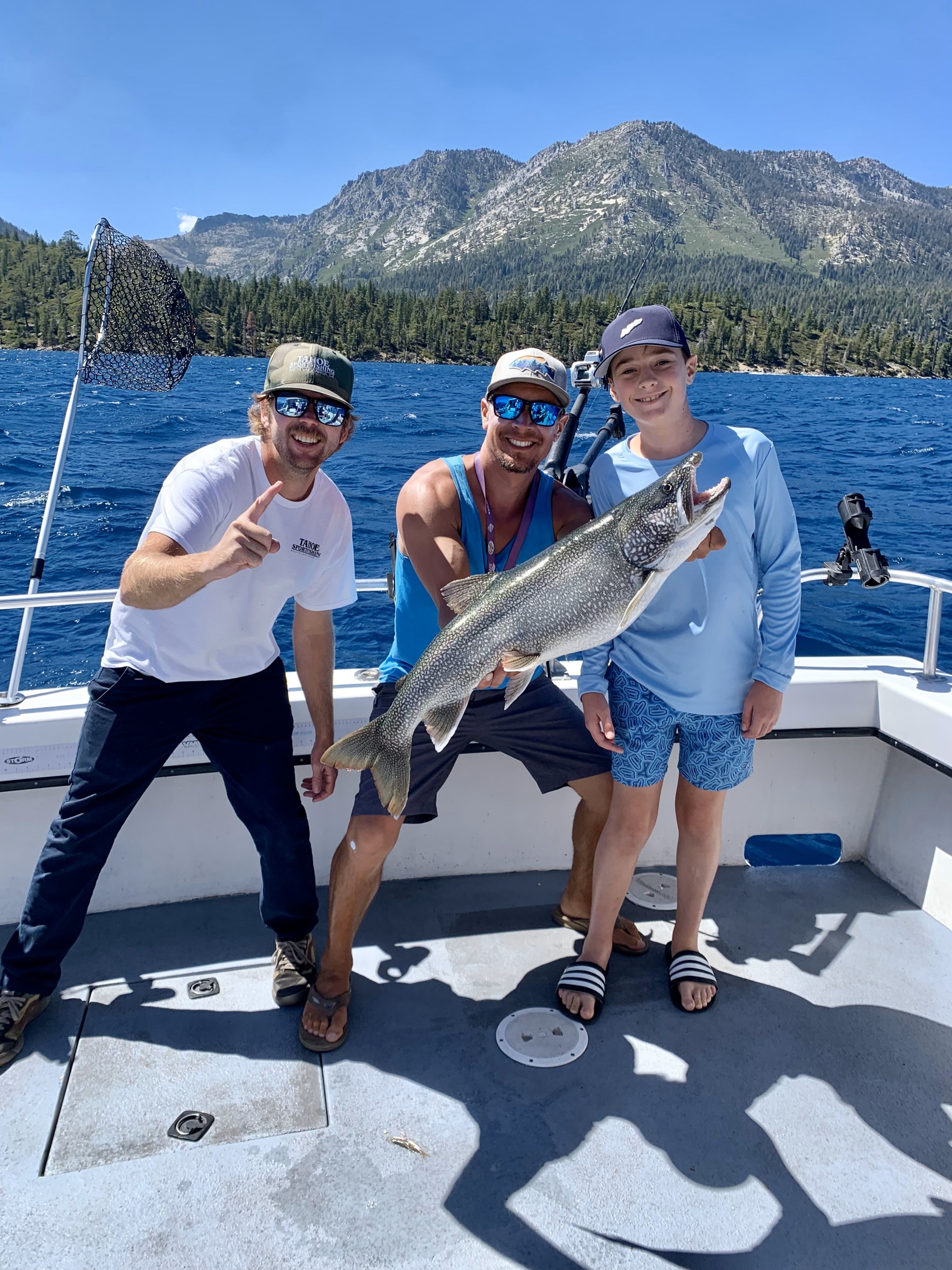 a group of people standing on top of a mountain